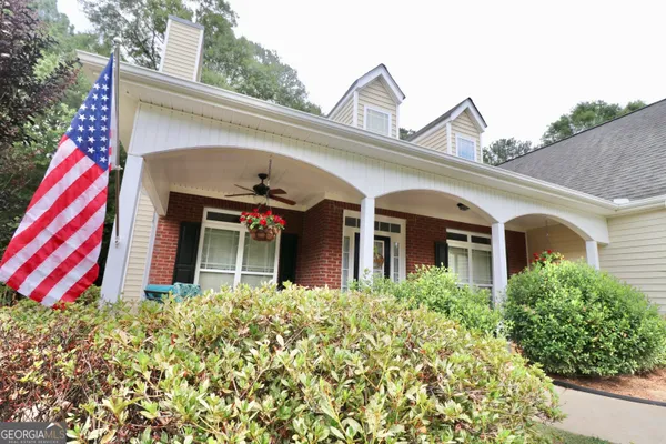 a front view of a house with plants