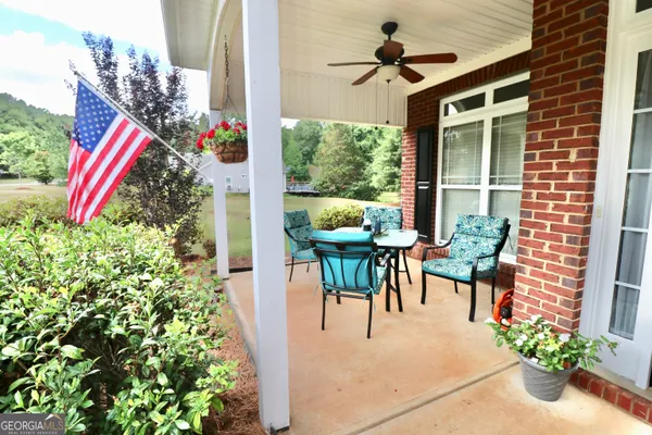 a view of a tables and chairs in patio with potted plants