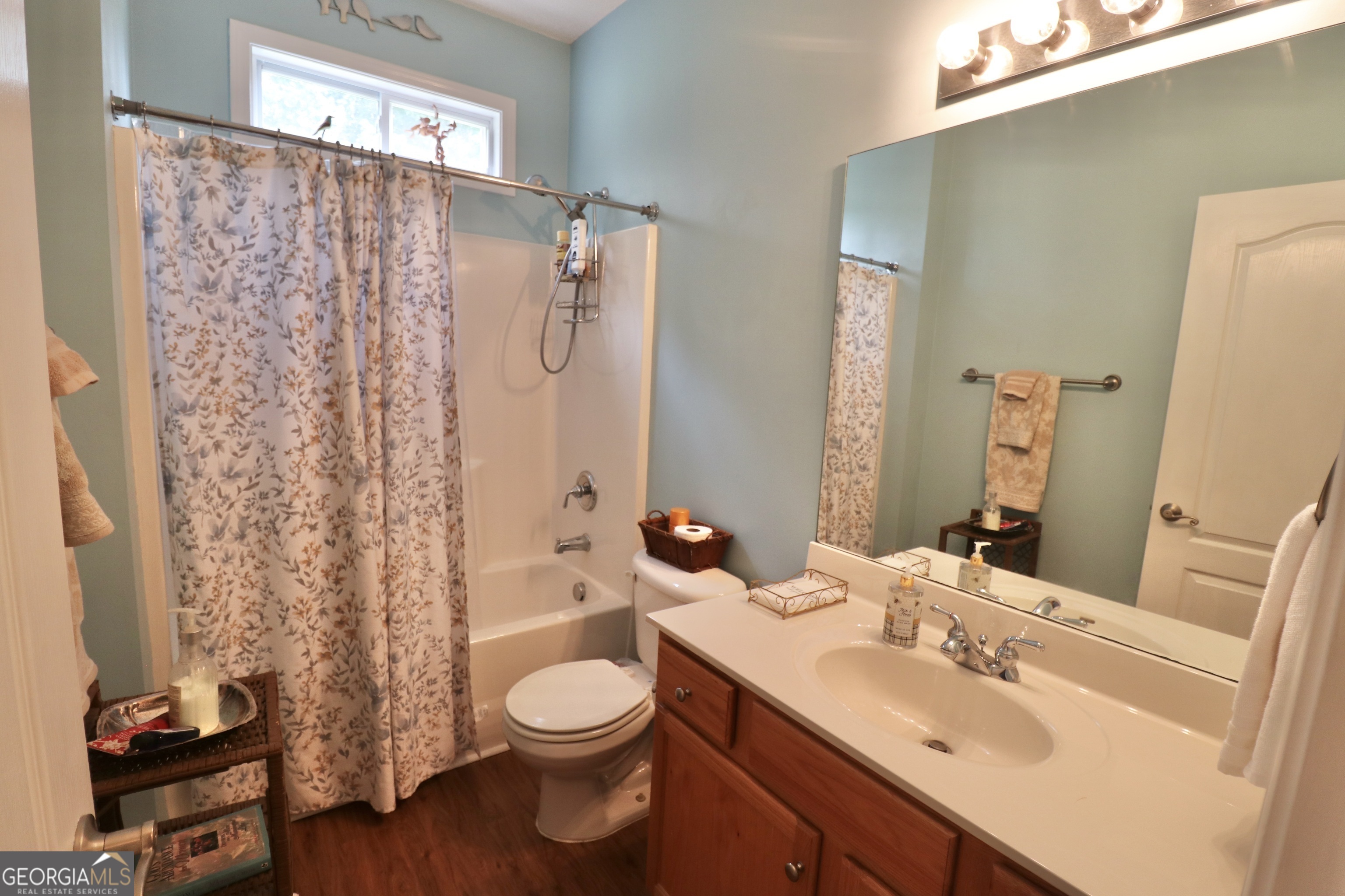 190 Roundtree Way Williamson, GA 30292 - Photo 54 of 73 a bathroom with a sink a toilet and shower curtain