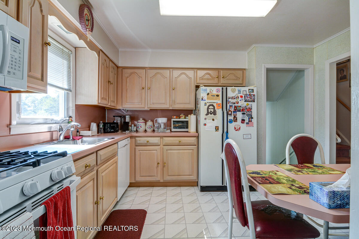 38 Ryan Boulevard Freehold, NJ 07728 - Photo 12 of 22 a kitchen with a stove a sink and a refrigerator