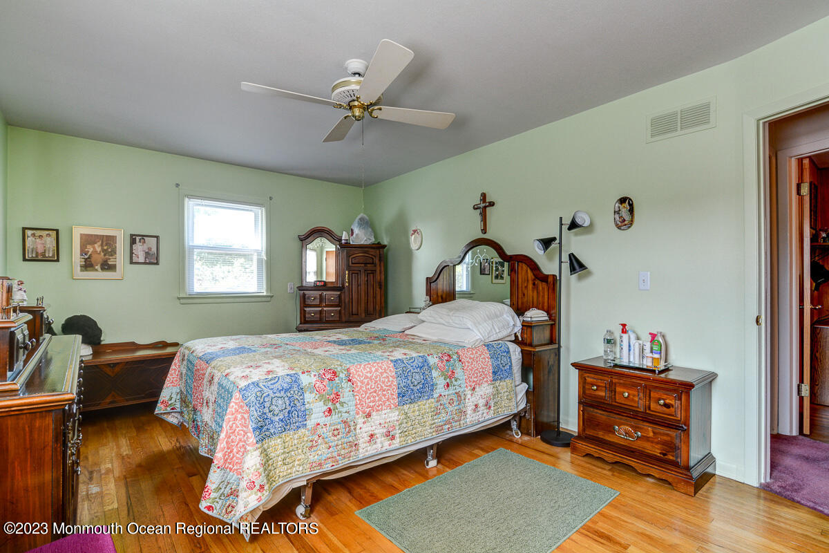 38 Ryan Boulevard Freehold, NJ 07728 - Photo 16 of 22 a bedroom with a bed and wooden floor