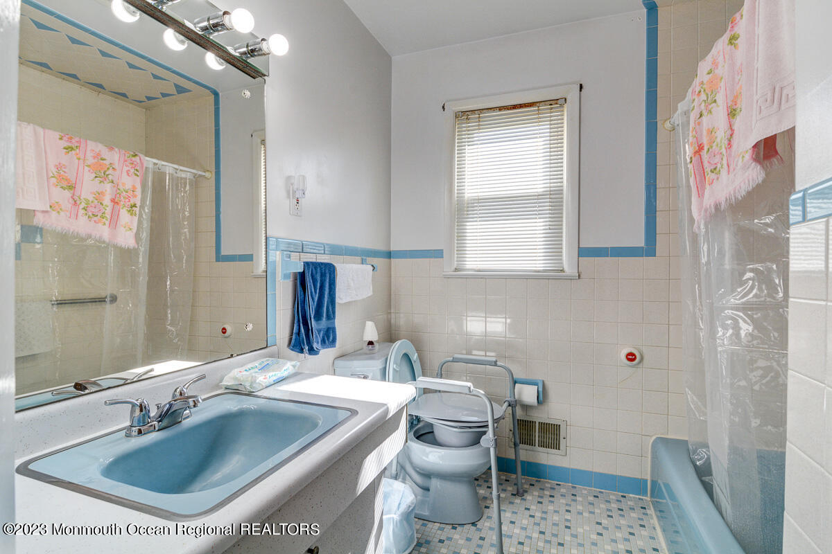 38 Ryan Boulevard Freehold, NJ 07728 - Photo 17 of 22 a bathroom with a sink toilet a mirror and shower