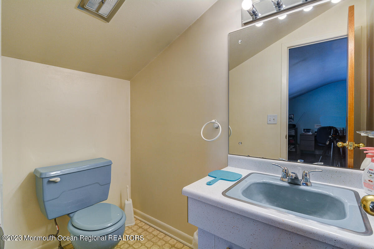 38 Ryan Boulevard Freehold, NJ 07728 - Photo 22 of 22 a bathroom with a toilet a sink and mirror