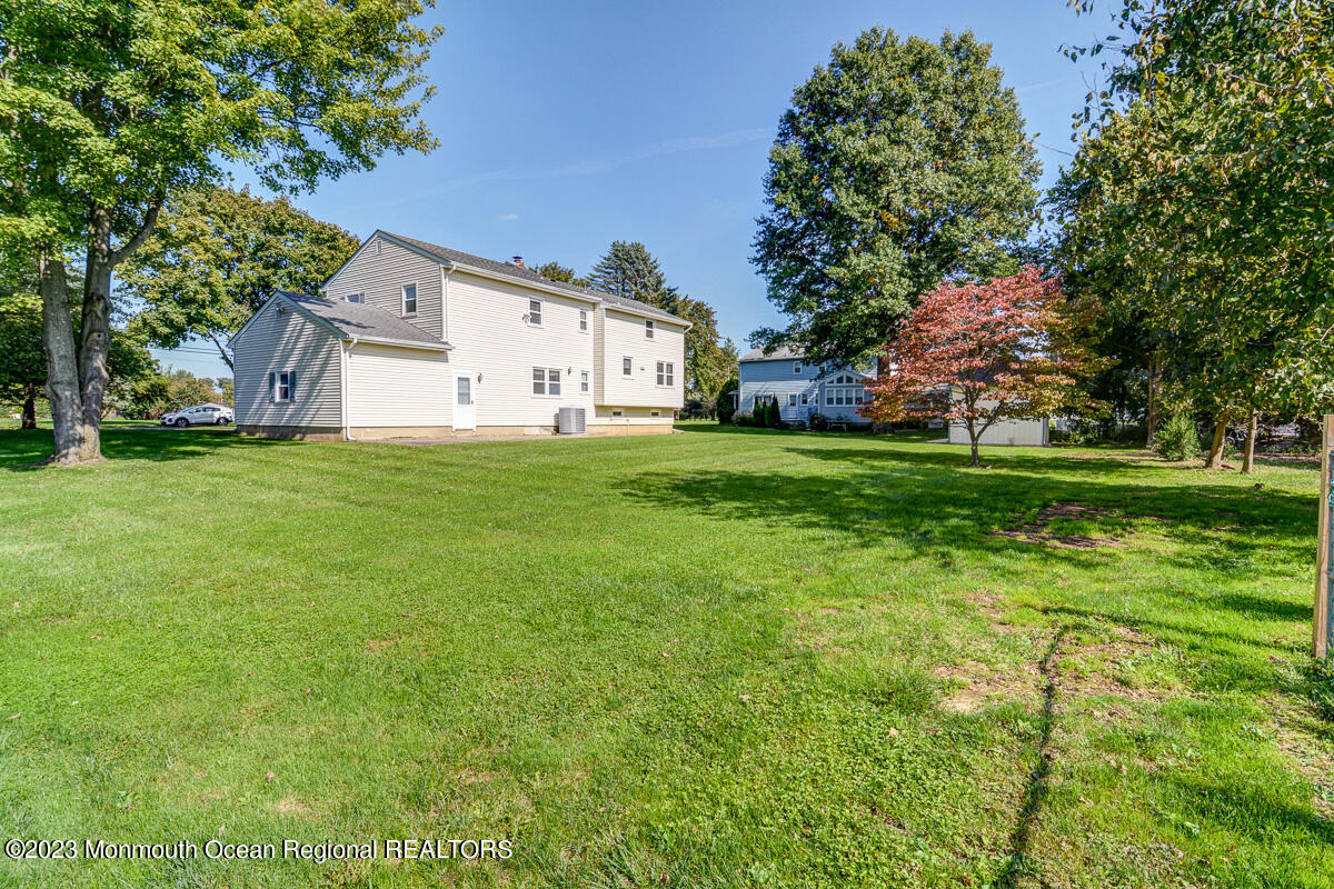 38 Ryan Boulevard Freehold, NJ 07728 - Photo 4 of 22 a big white house with a big yard and large trees