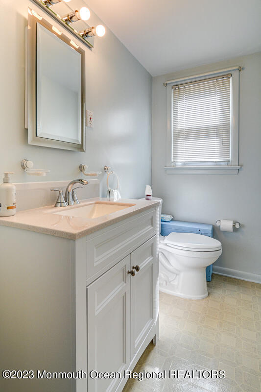 38 Ryan Boulevard Freehold, NJ 07728 - Photo 8 of 22 a bathroom with a sink a toilet and mirror