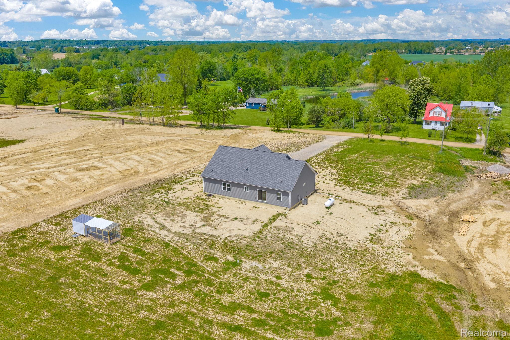 7600 Church Road Imlay City, MI 48444 - Photo 9 of 38 Newly constructed single-story residence featuring gray siding and a dark gray shingled roof