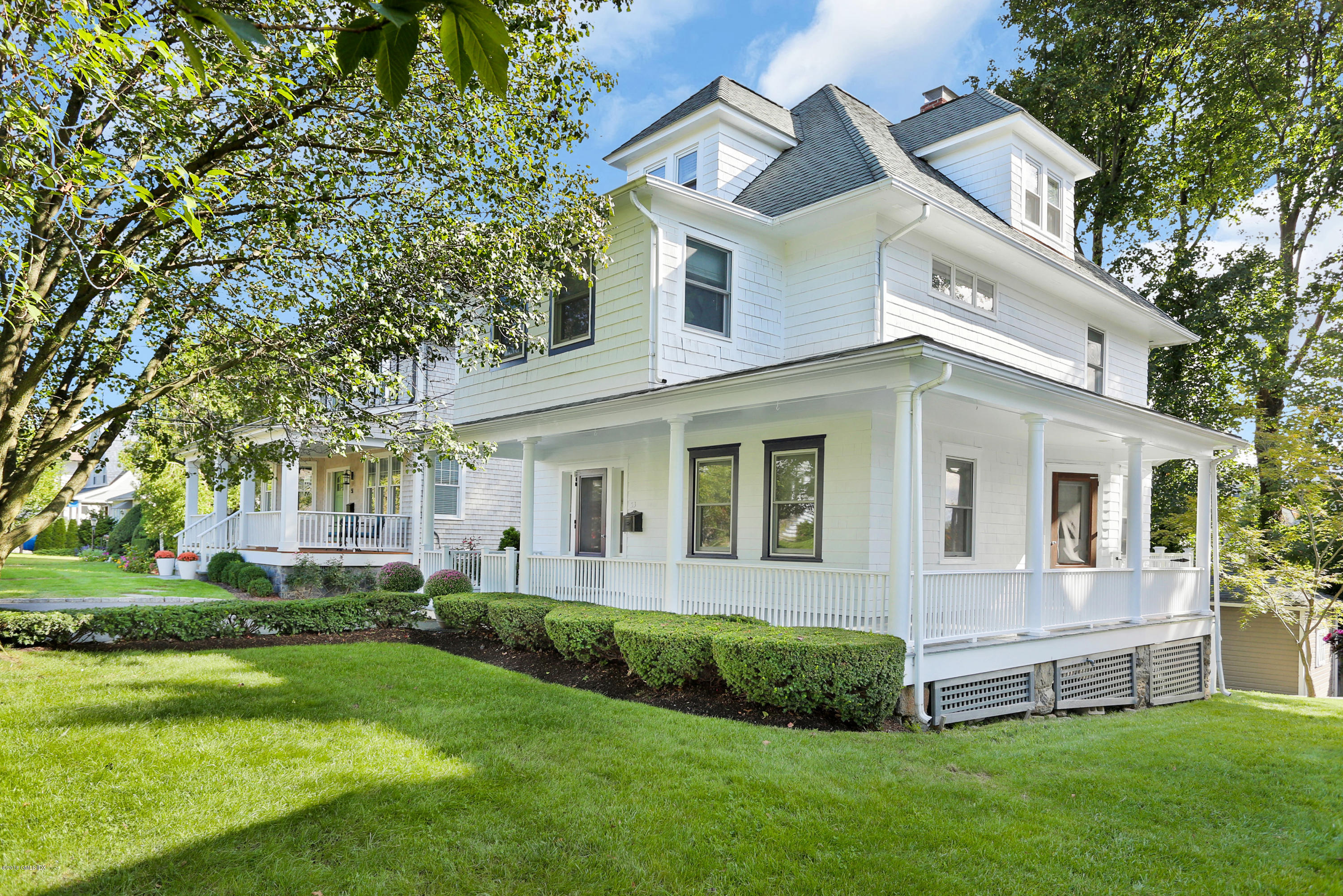 a front view of a house with a garden and yard