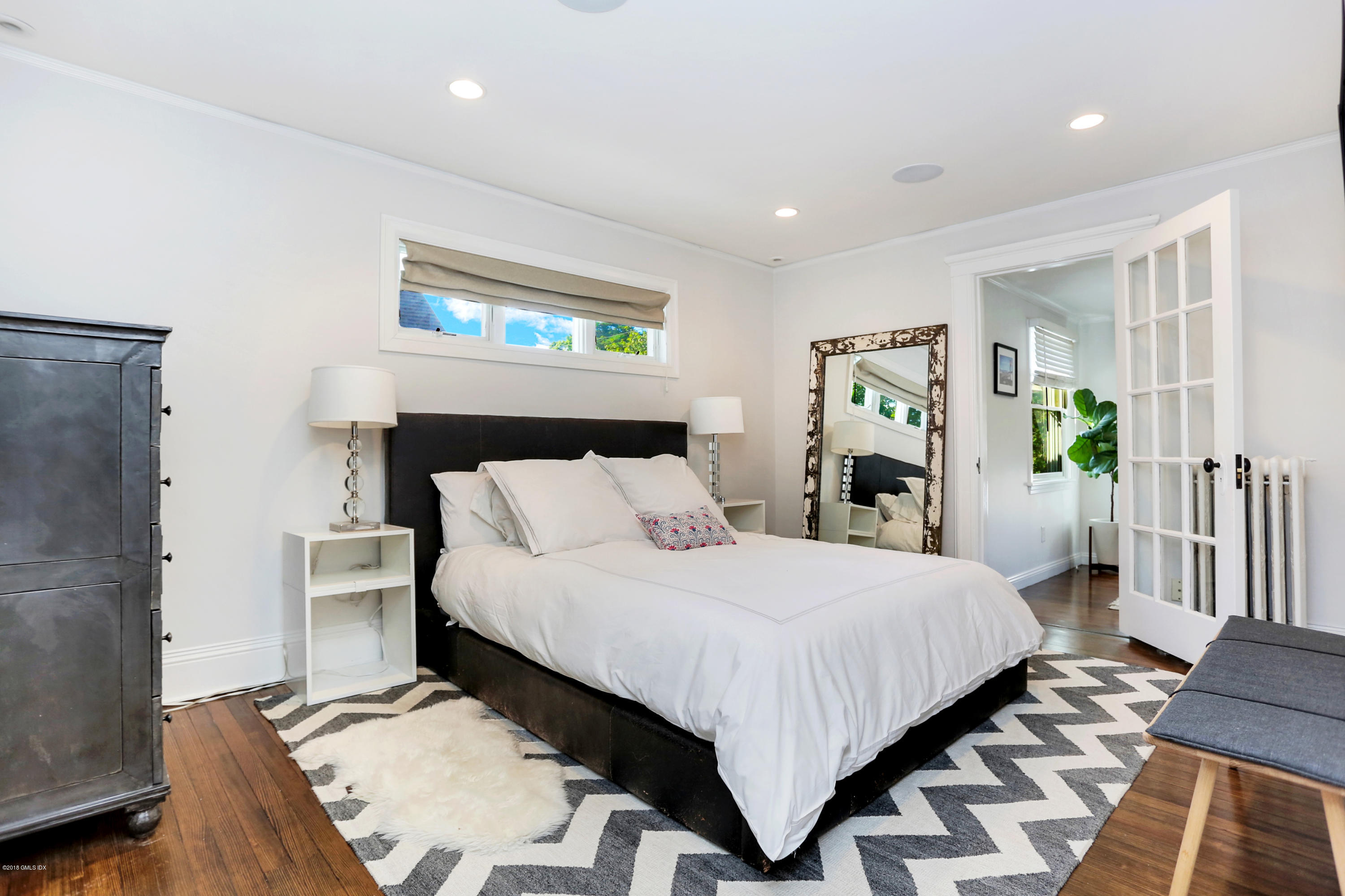 53 Ridge Street Greenwich, CT 06830 - Photo 11 of 17 a bedroom with a bed and a dresser