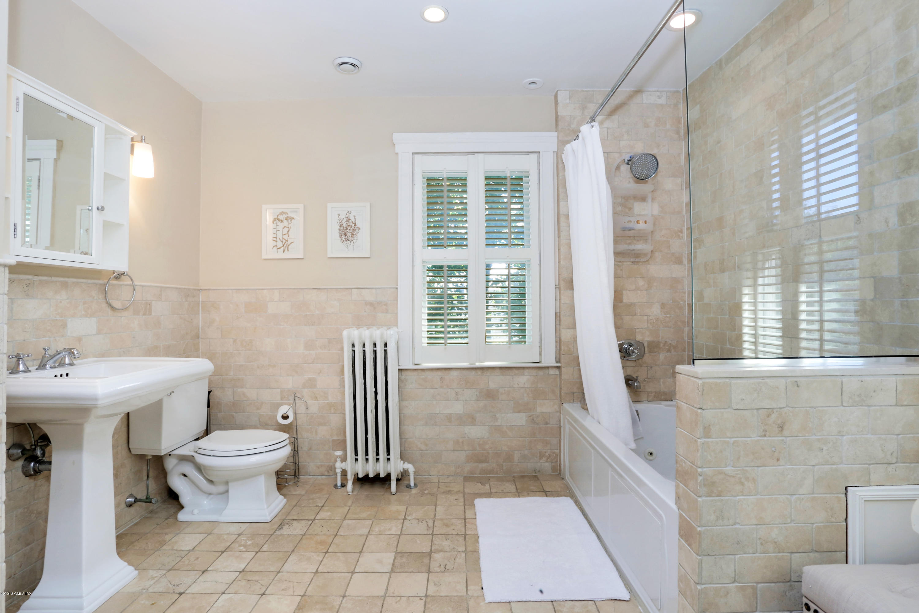 53 Ridge Street Greenwich, CT 06830 - Photo 13 of 17 a bathroom with a toilet sink and mirror