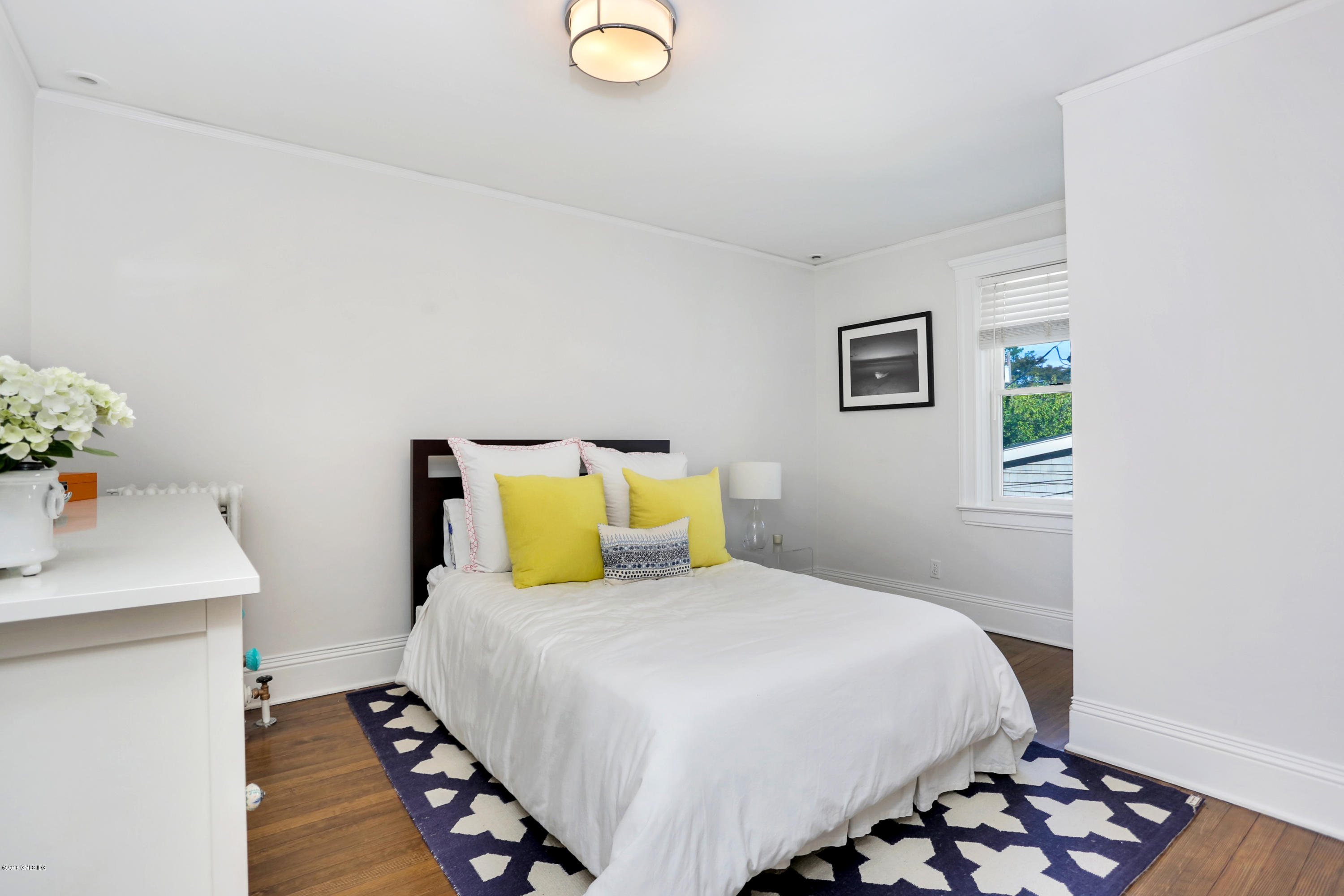 53 Ridge Street Greenwich, CT 06830 - Photo 14 of 17 a bedroom with a bed and a dresser