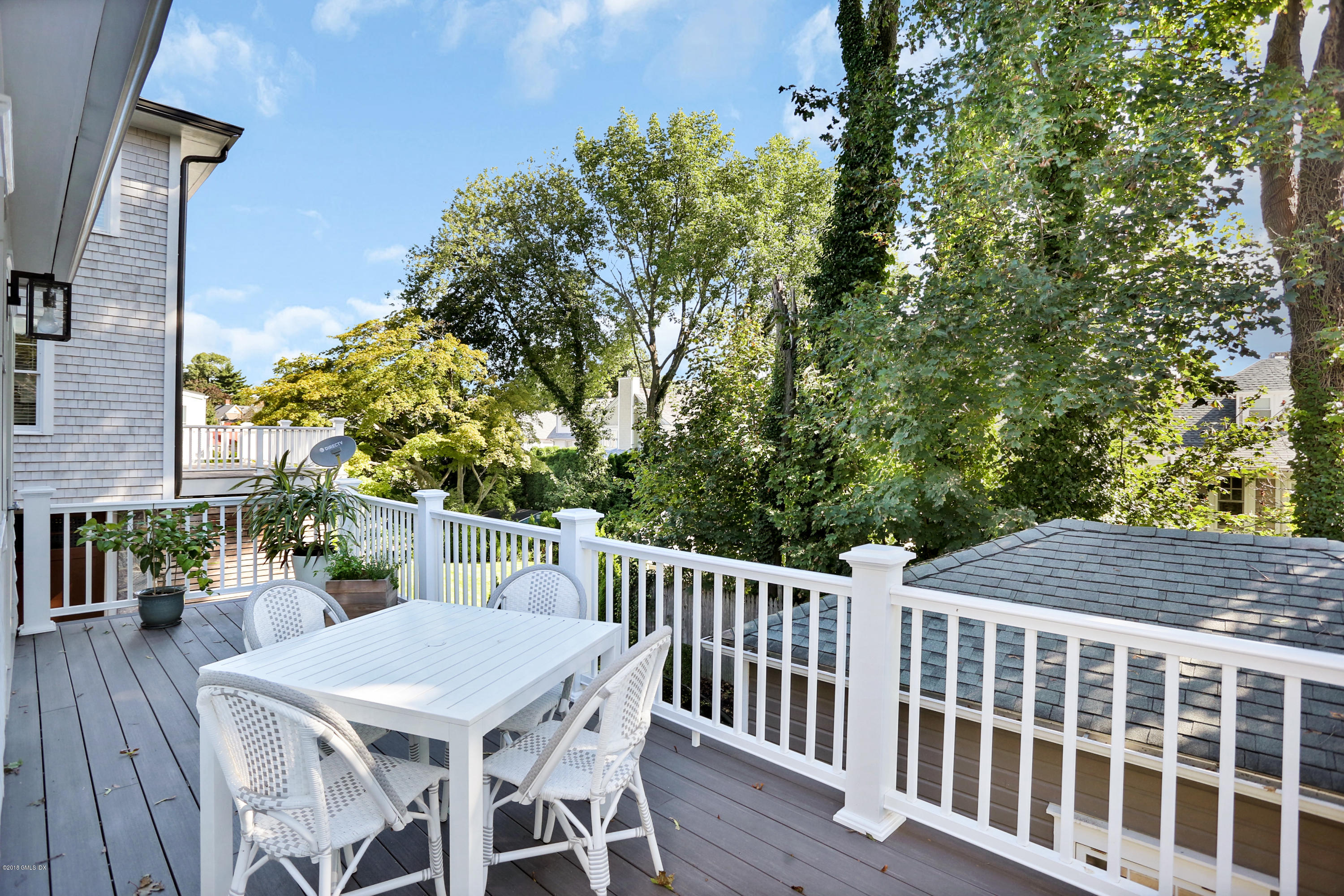 53 Ridge Street Greenwich, CT 06830 - Photo 16 of 17 a view of a patio with table and chairs with wooden floor and fence