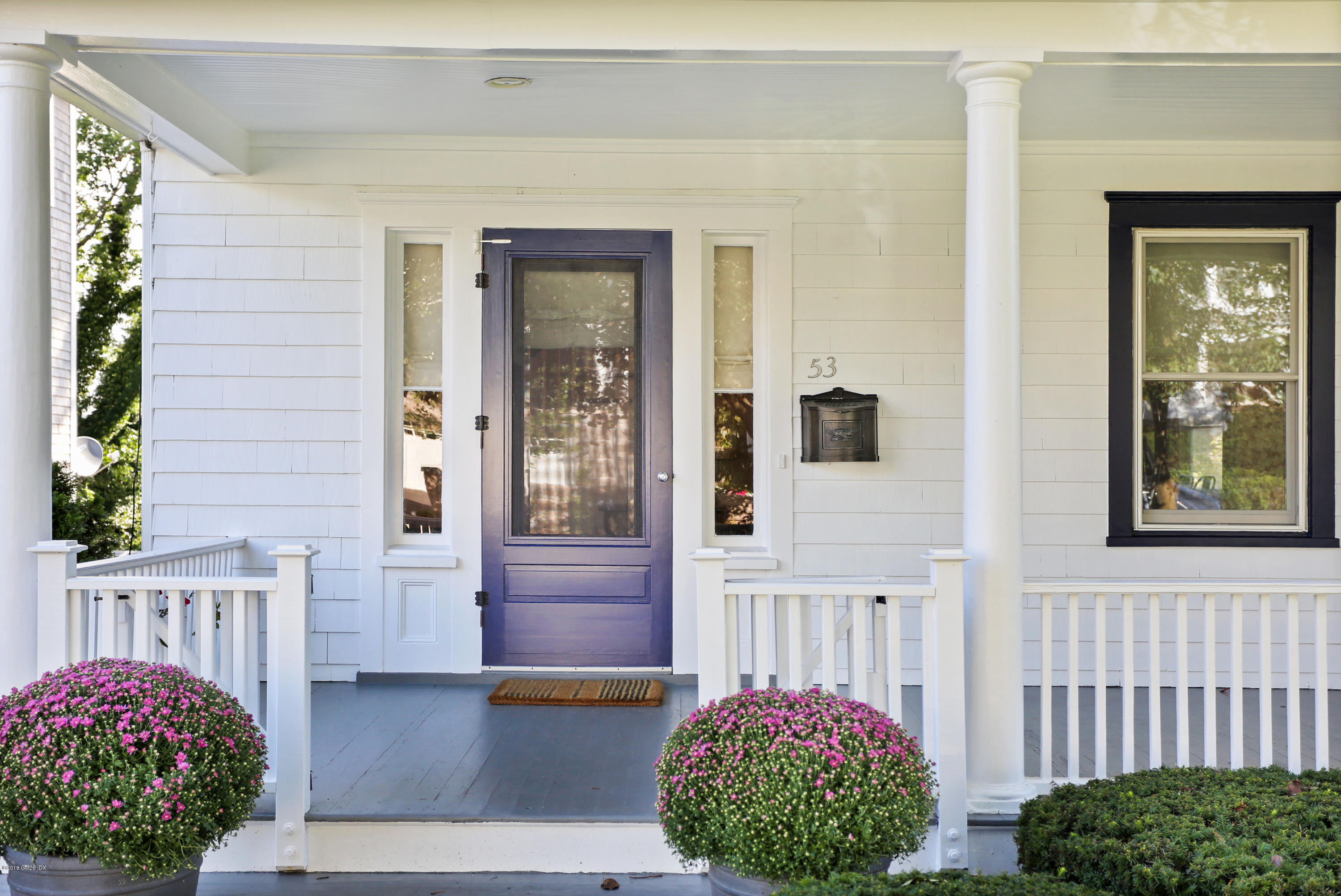 53 Ridge Street Greenwich, CT 06830 - Photo 3 of 17 a front view of a house with a garden
