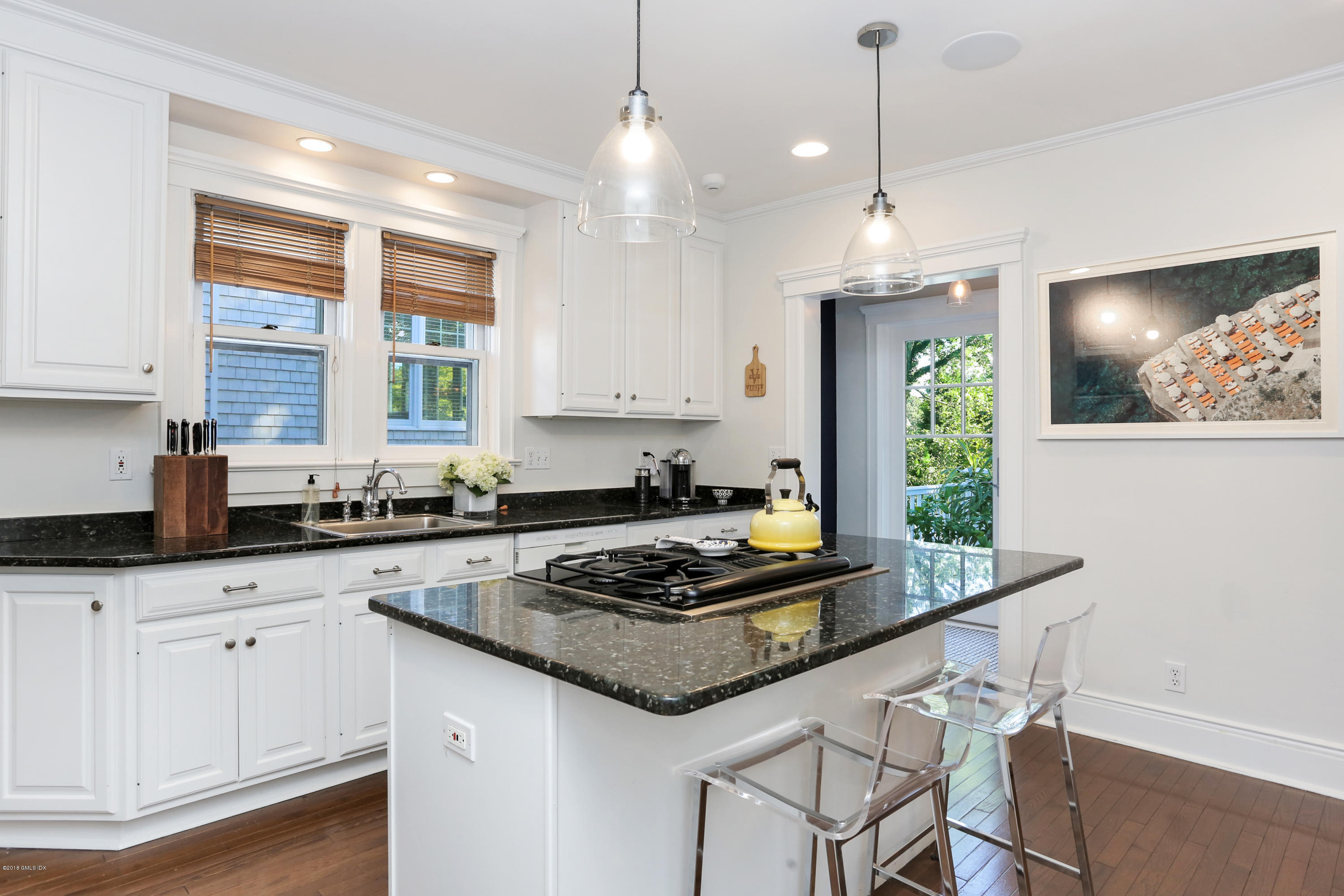 53 Ridge Street Greenwich, CT 06830 - Photo 9 of 17 a kitchen with granite countertop a stove a sink a center island and cabinets