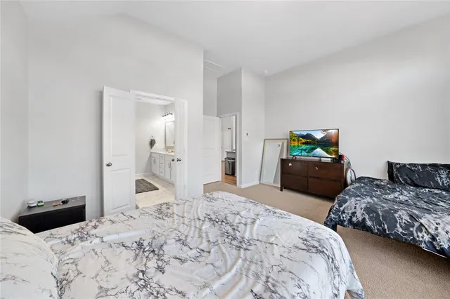 a bedroom with bed and mirror