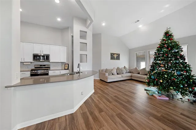 a living room with furniture potted plant and flowers