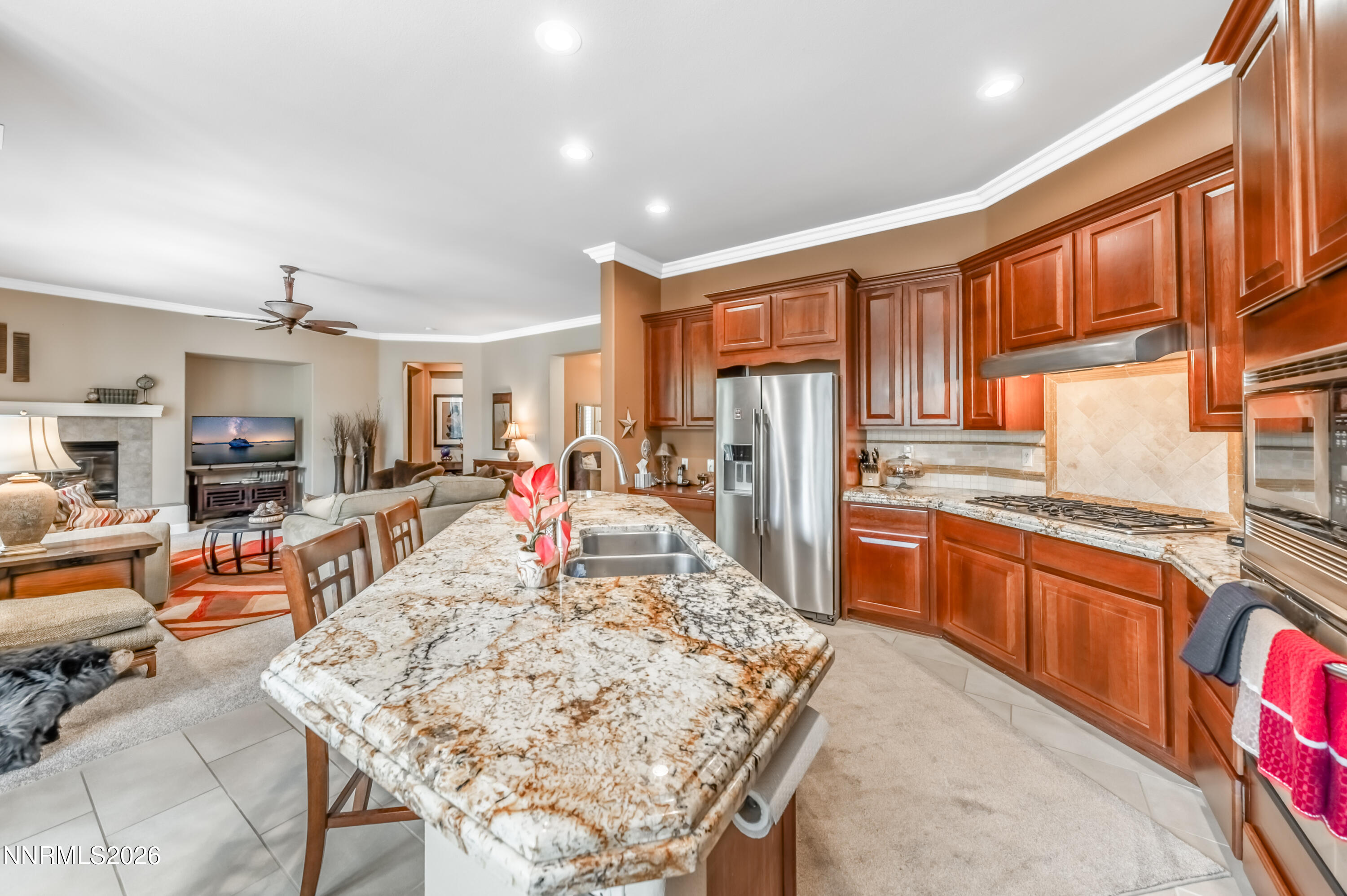 5865 Slate Drive Reno, NV 89523 - Photo 8 of 23 a large kitchen with stainless steel appliances granite countertop a refrigerator a stove top oven and a dining table