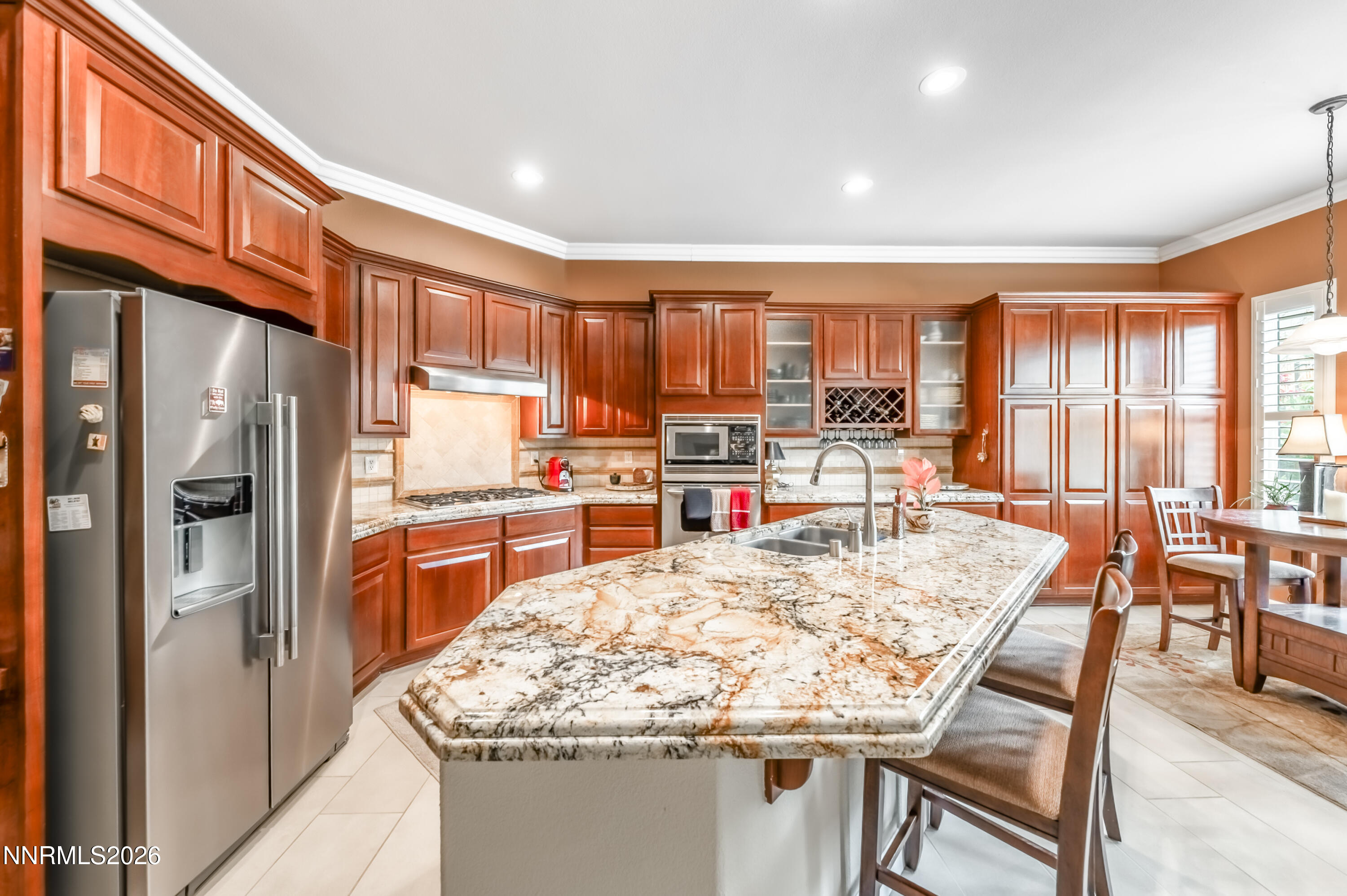 5865 Slate Drive Reno, NV 89523 - Photo 10 of 23 a kitchen with stainless steel appliances granite countertop a refrigerator and a stove top oven