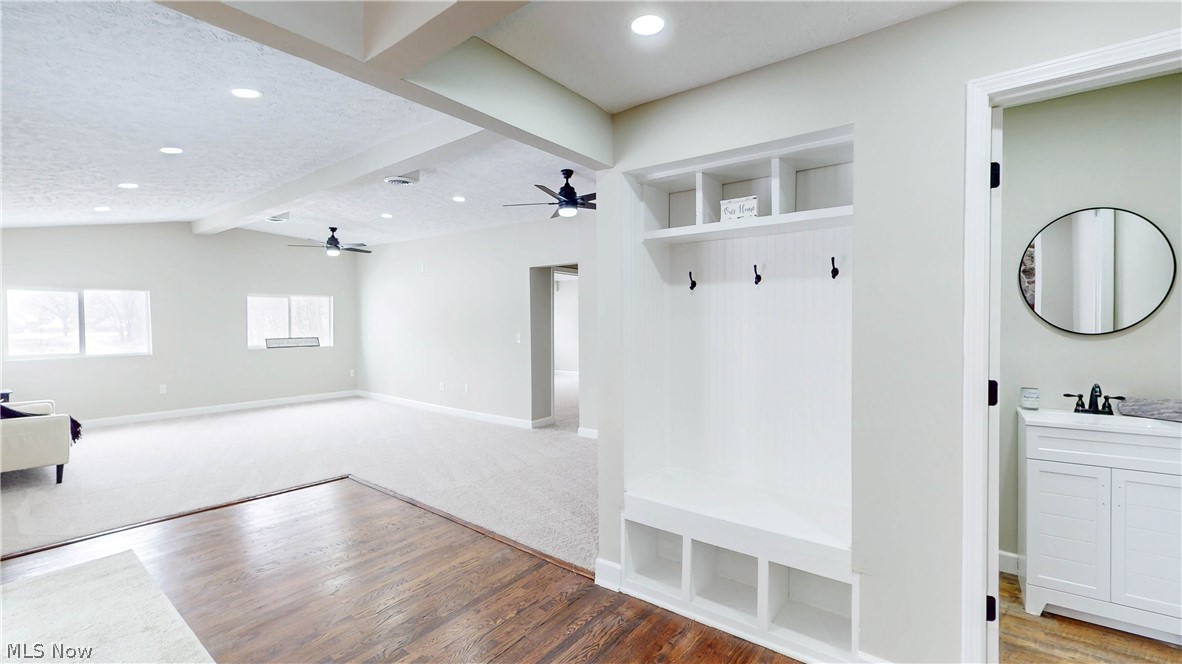 3312 Bancroft Road Akron, OH 44333 - Photo 11 of 50 Mudroom with light wood finished floors, beam ceiling, recessed lighting, and a textured ceiling