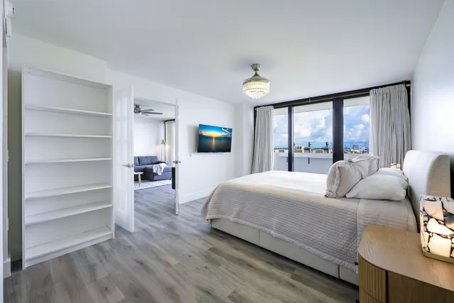 a bedroom with a large bed and a large window