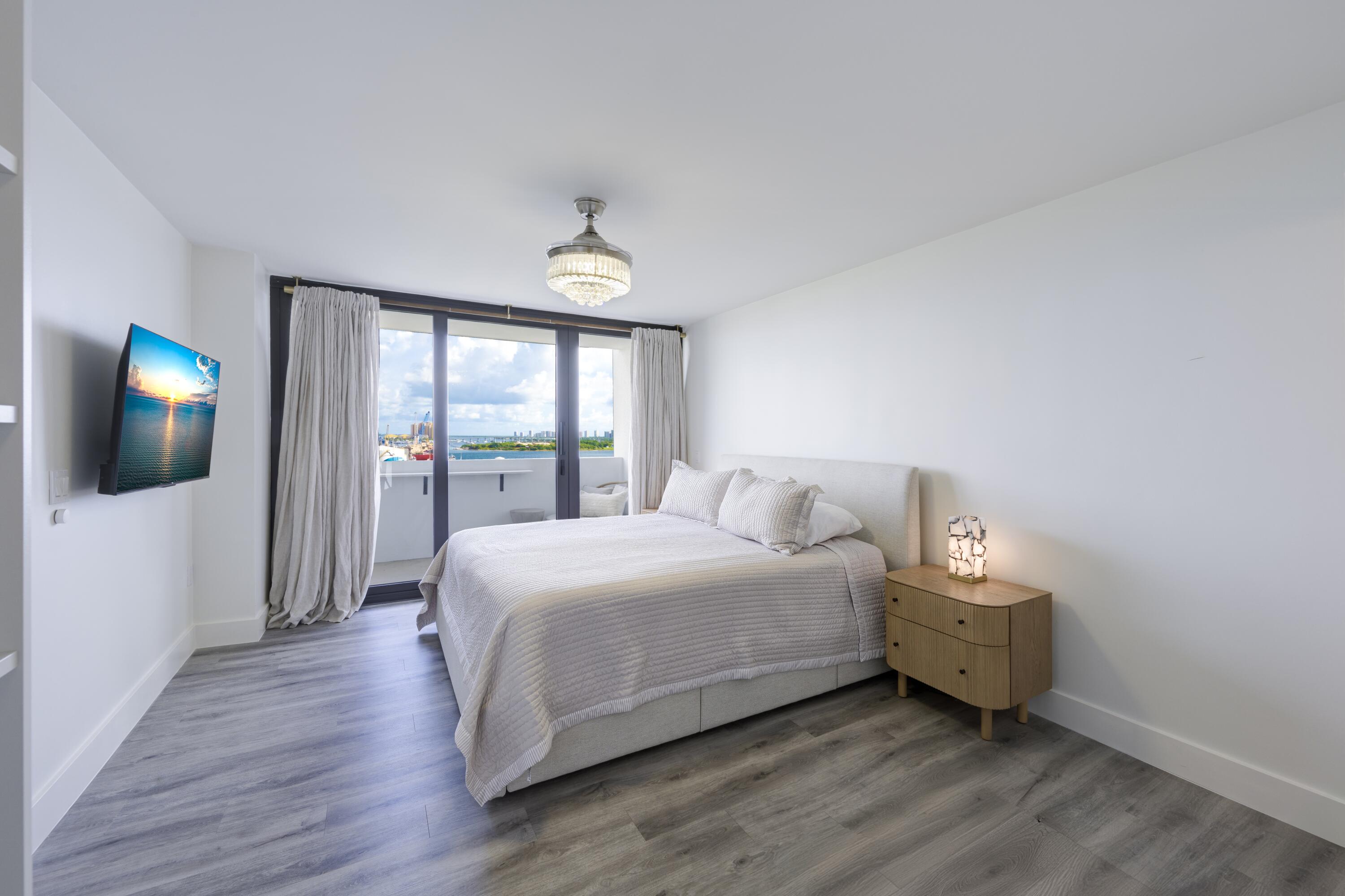 5600 North Flagler Drive, Unit 1207 West Palm Beach, FL 33407 - Photo 12 of 32 a bedroom with a bed and a window