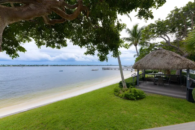 a view of a backyard with lawn chairs and a fire pit