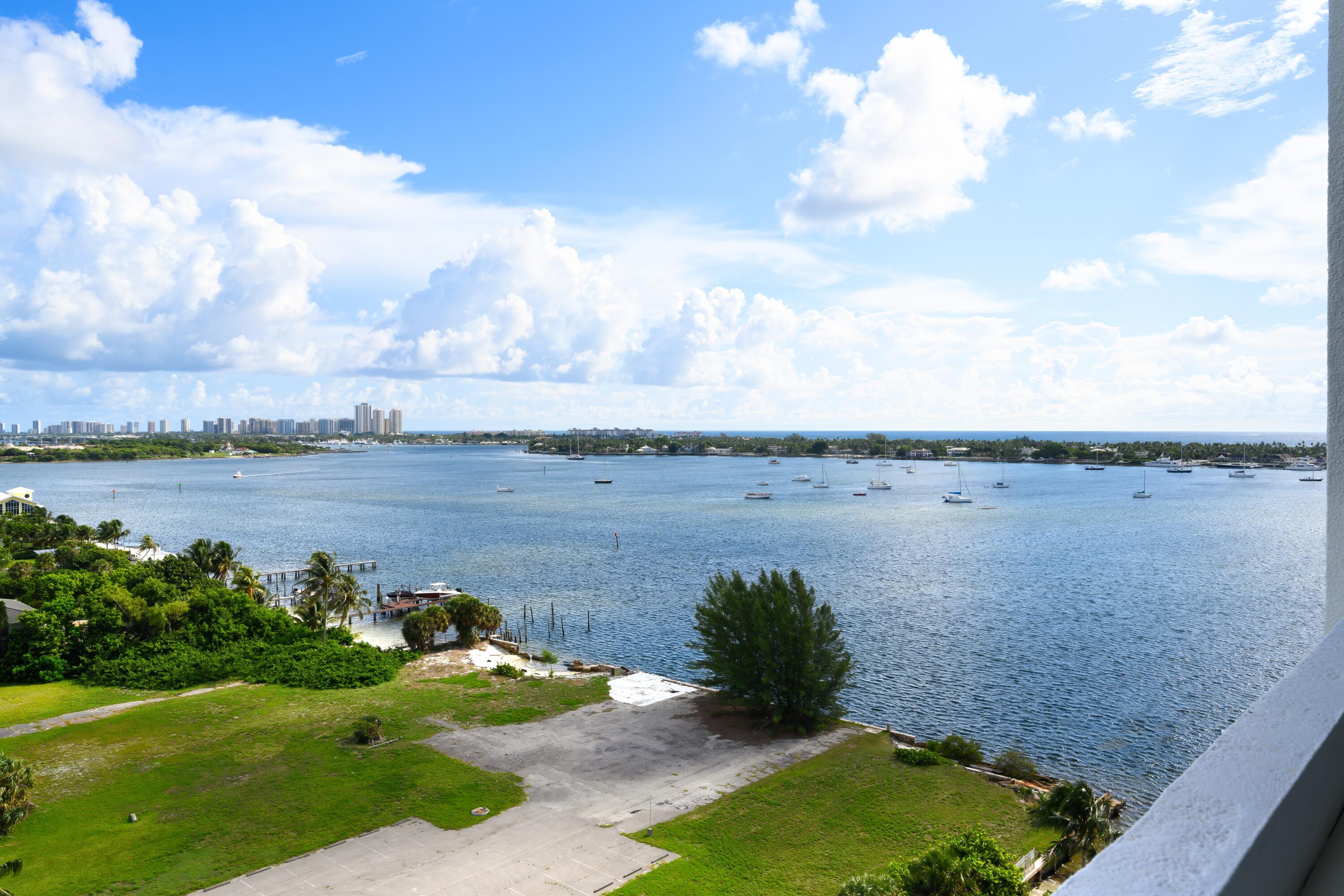 5600 North Flagler Drive, Unit 1207 West Palm Beach, FL 33407 - Photo 4 of 32 a view of a lake with houses in the back