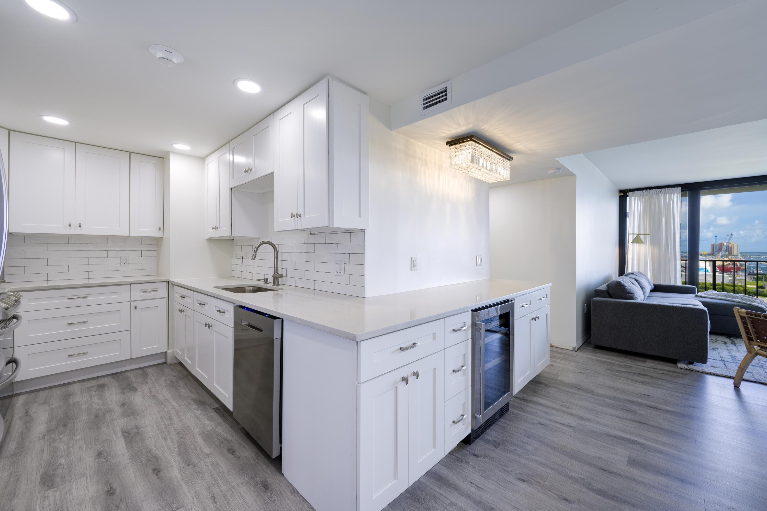 5600 North Flagler Drive, Unit 1207 West Palm Beach, FL 33407 - Photo 9 of 32 a large kitchen with cabinets wooden floor and stainless steel appliances