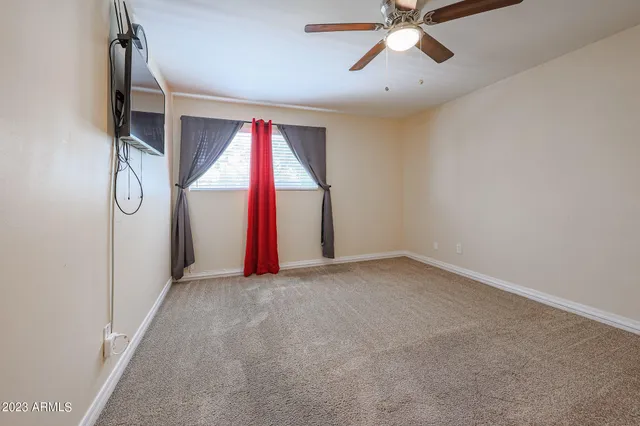 a view of empty room with ceiling fan