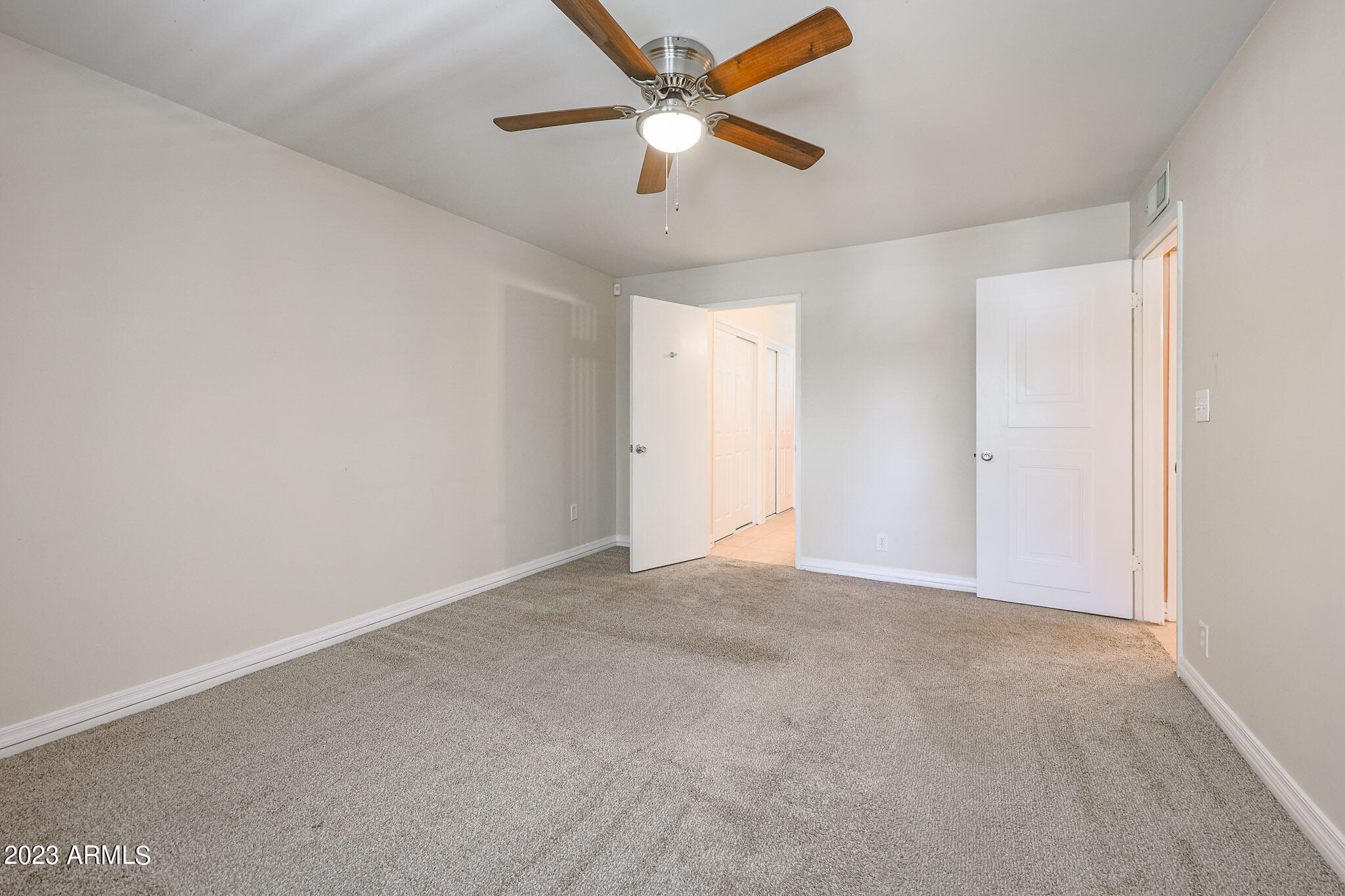 5550 North 12th Street, Unit 24 Phoenix, AZ 85014 - Photo 13 of 20 an empty room with closet and a ceiling fan