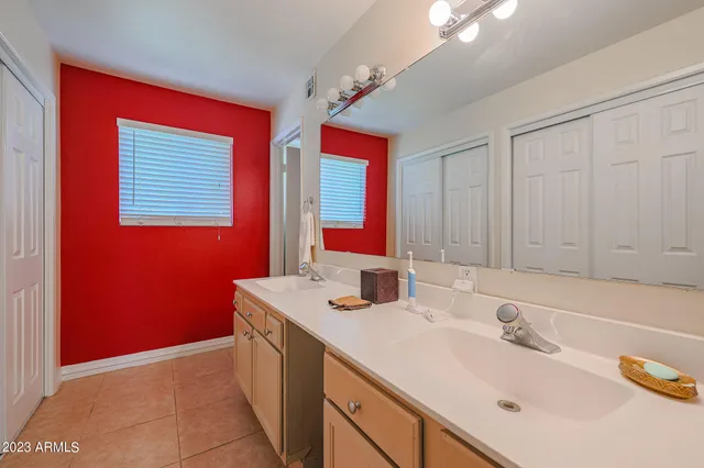 a bathroom with a sink vanity and a mirror