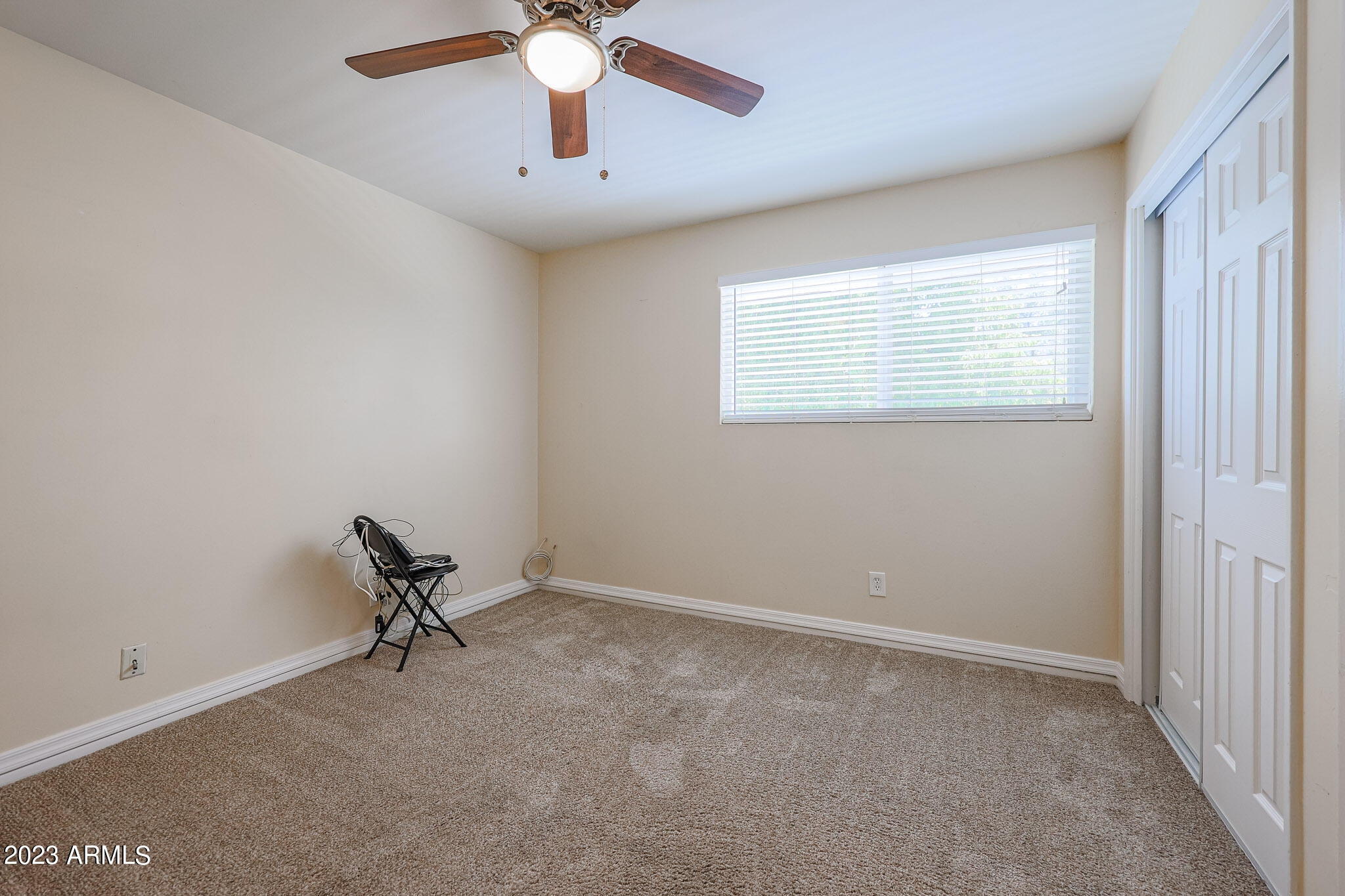 5550 North 12th Street, Unit 24 Phoenix, AZ 85014 - Photo 15 of 20 an empty room with a window and a fan
