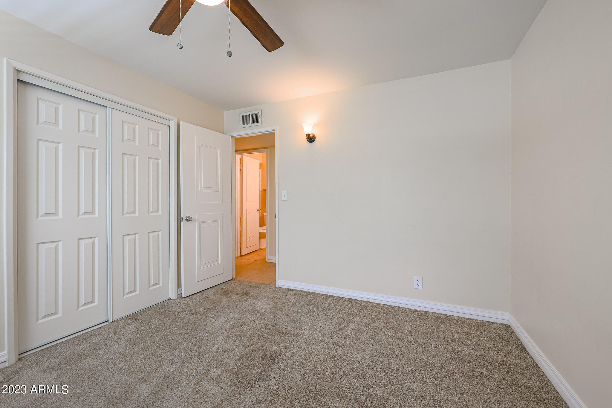 5550 North 12th Street, Unit 24 Phoenix, AZ 85014 - Photo 16 of 20 an empty room with chandelier fan