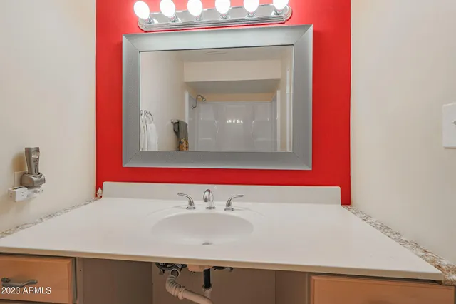 a bathroom with a sink and a mirror