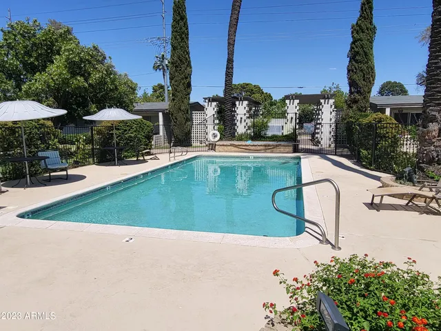 a view of a swimming pool and lounge chairs