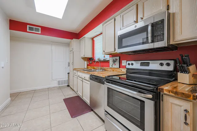 a kitchen with stainless steel appliances granite countertop a stove and a microwave