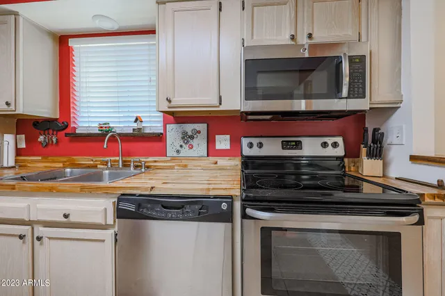 a kitchen with stainless steel appliances granite countertop a stove and a microwave