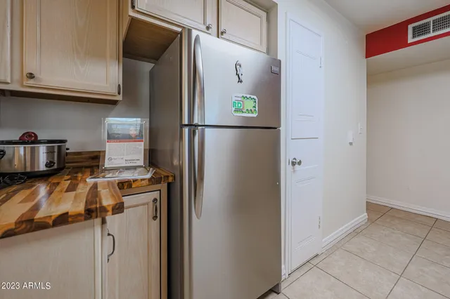 a kitchen with stainless steel appliances granite countertop a refrigerator and a stove