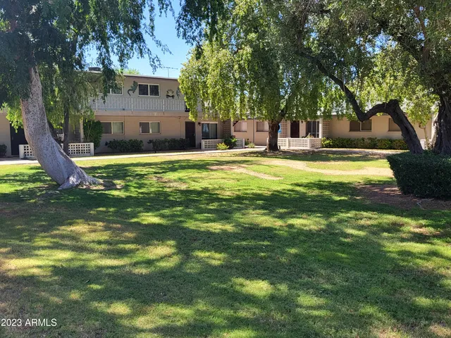 a swimming pool with outdoor seating and yard