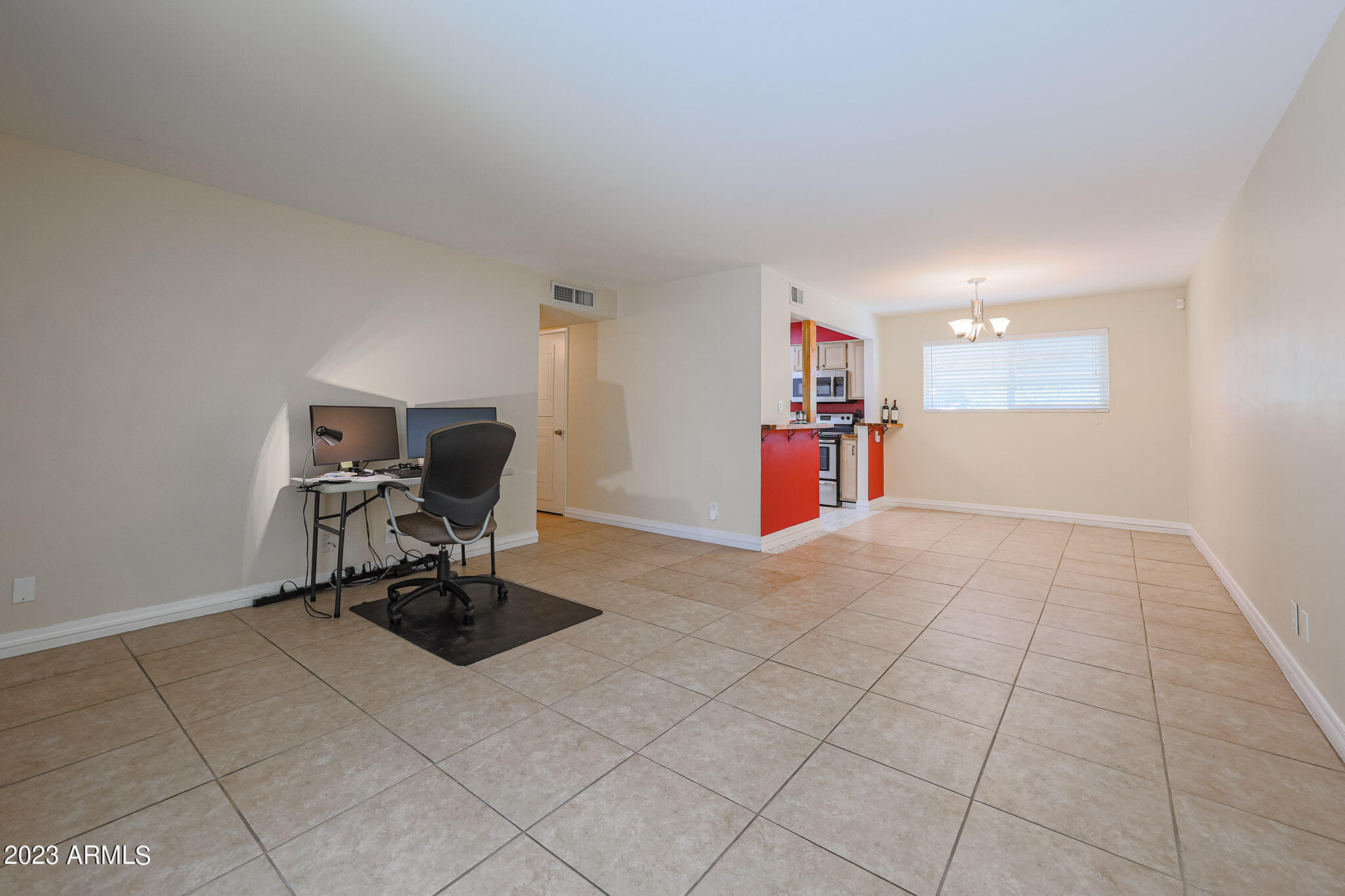 5550 North 12th Street, Unit 24 Phoenix, AZ 85014 - Photo 8 of 20 a view of a workspace with furniture and a window