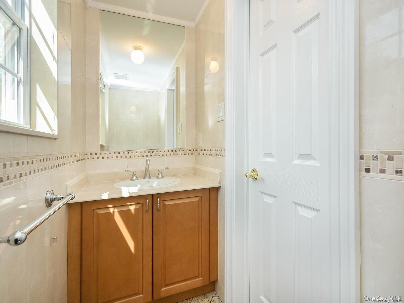 51 Inwood Road, Unit B Port Washington, NY 11050 - Photo 13 of 33 a bathroom with a sink and a mirror