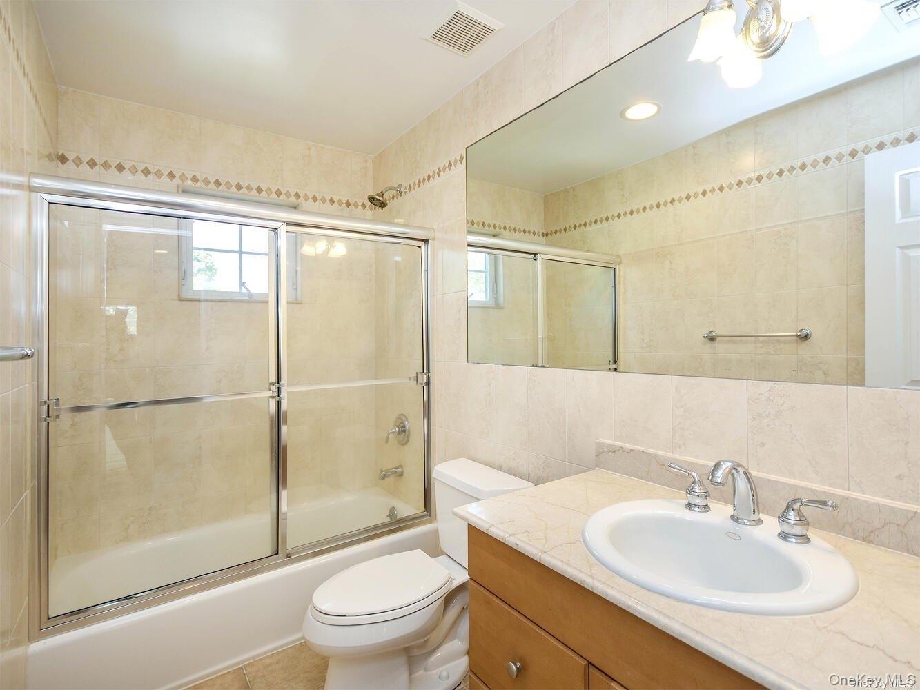 51 Inwood Road, Unit B Port Washington, NY 11050 - Photo 18 of 33 a bathroom with a sink toilet and shower
