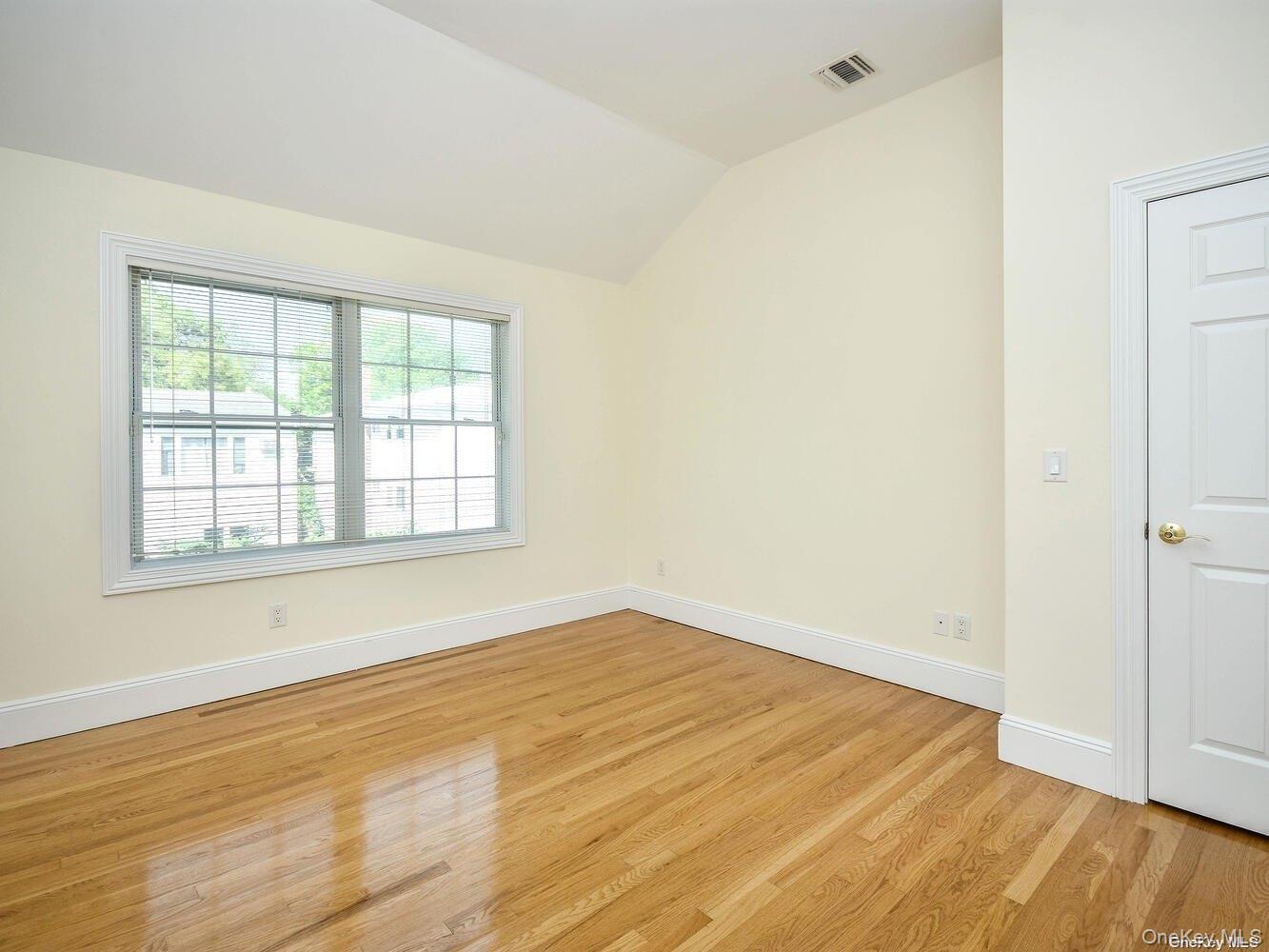 51 Inwood Road, Unit B Port Washington, NY 11050 - Photo 19 of 33 an empty room with wooden floor and windows