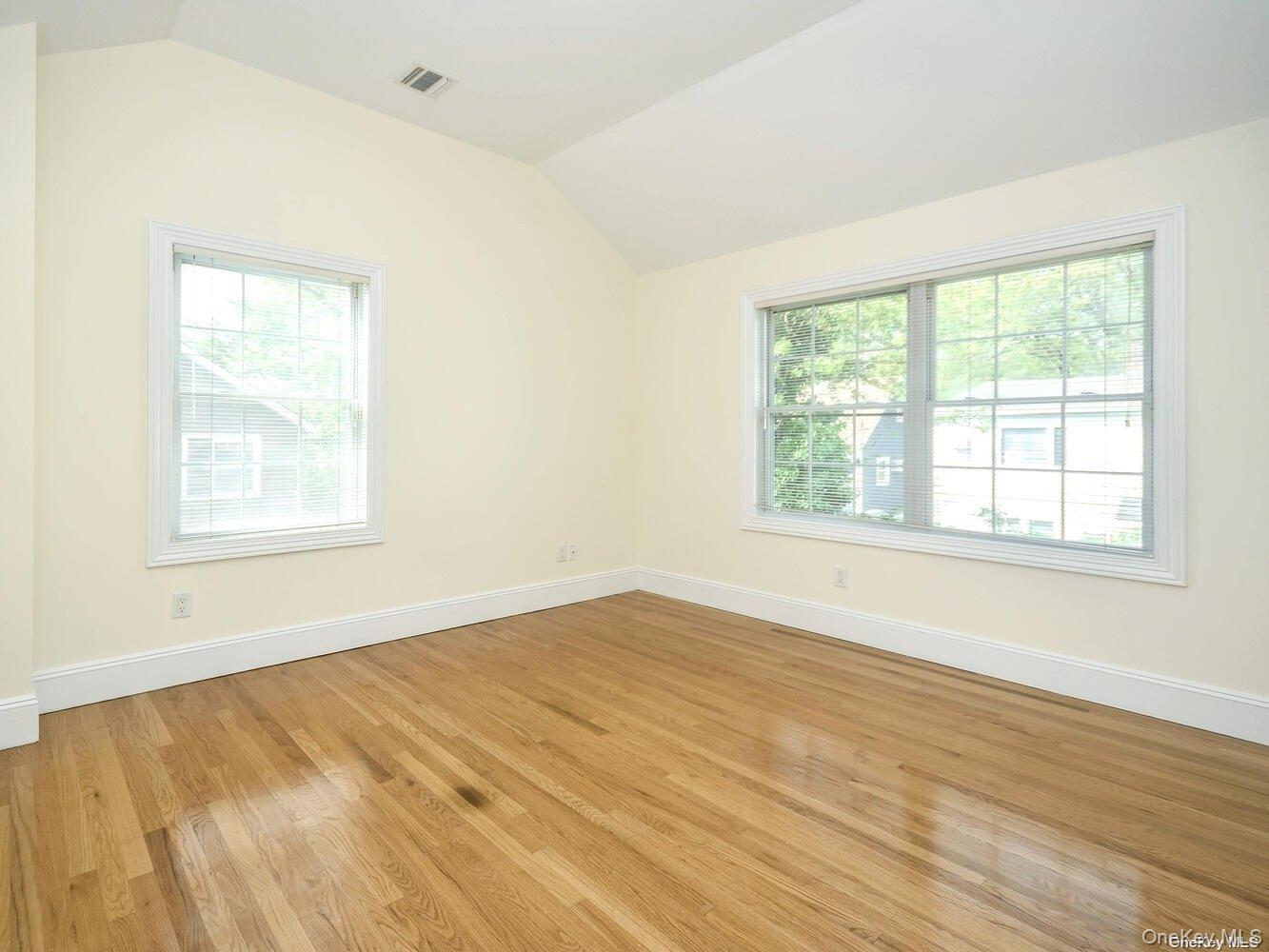 51 Inwood Road, Unit B Port Washington, NY 11050 - Photo 22 of 33 a view of an empty room with wooden floor and a window