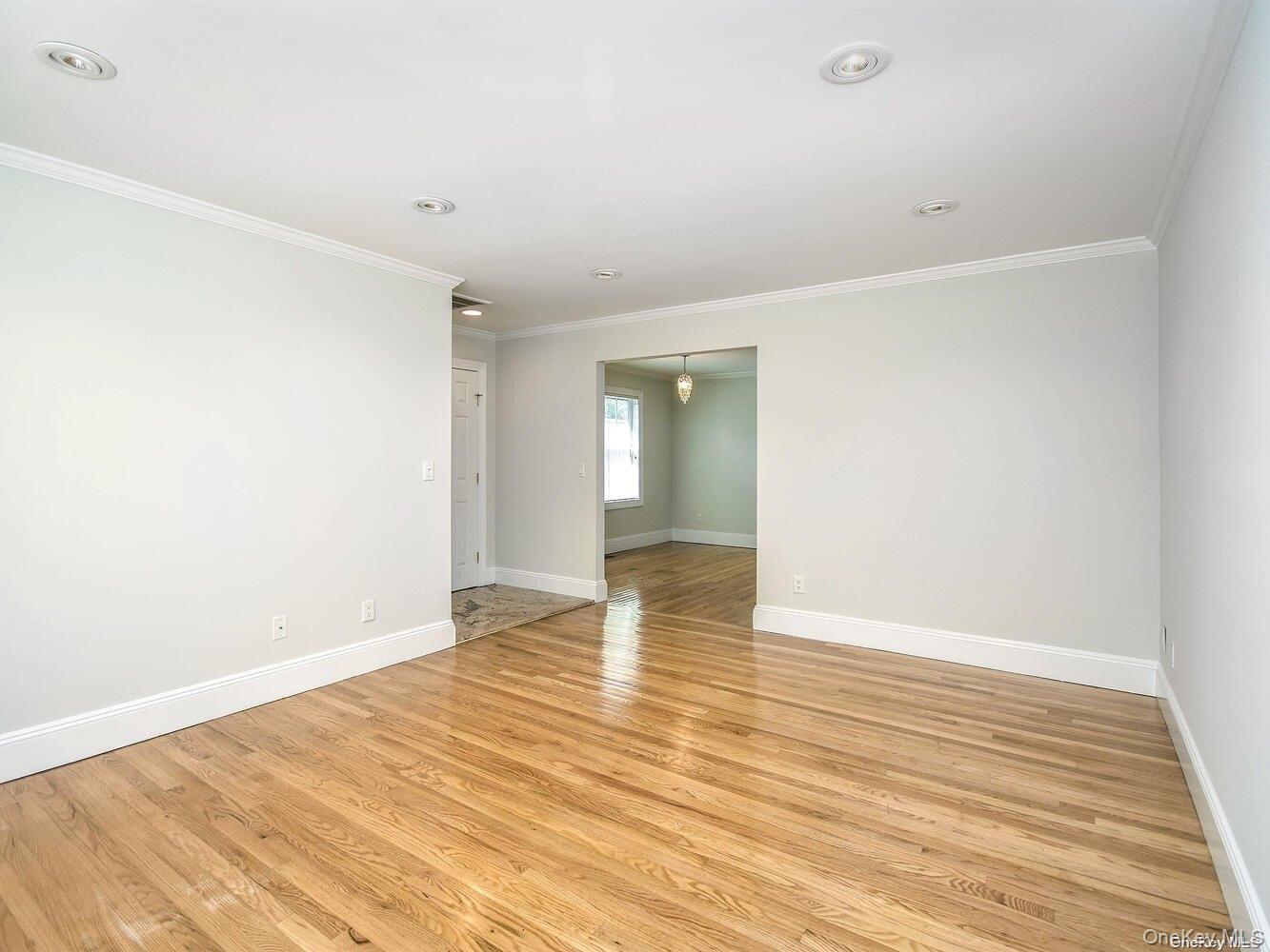 51 Inwood Road, Unit B Port Washington, NY 11050 - Photo 5 of 33 a view of an empty room with wooden floor