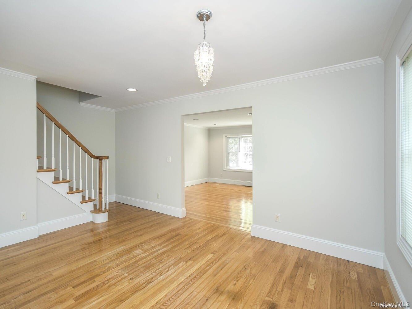 51 Inwood Road, Unit B Port Washington, NY 11050 - Photo 6 of 33 a view of empty room with wooden floor and fan
