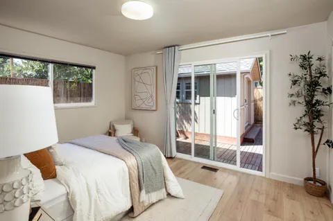 a bathroom with a granite countertop sink mirror and toilet
