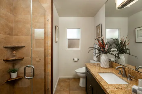 a view of backyard of house with seating space