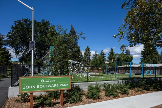 a view of a dining room with furniture and a potted plant