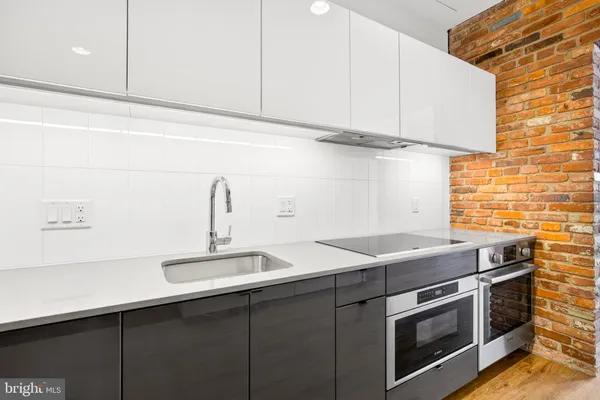 a kitchen with stainless steel appliances granite countertop a sink a stove and oven