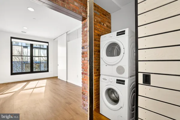 a view of a bedroom with washer and dryer